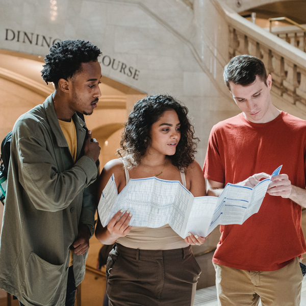 Group of people looking at map at tourist attraction