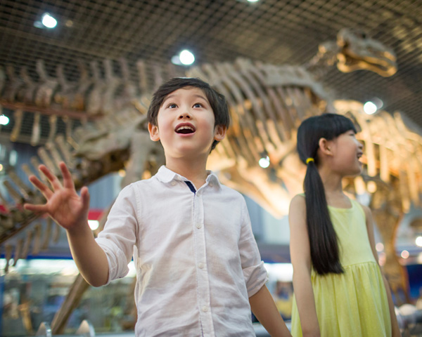 Two happy children exploring museum
